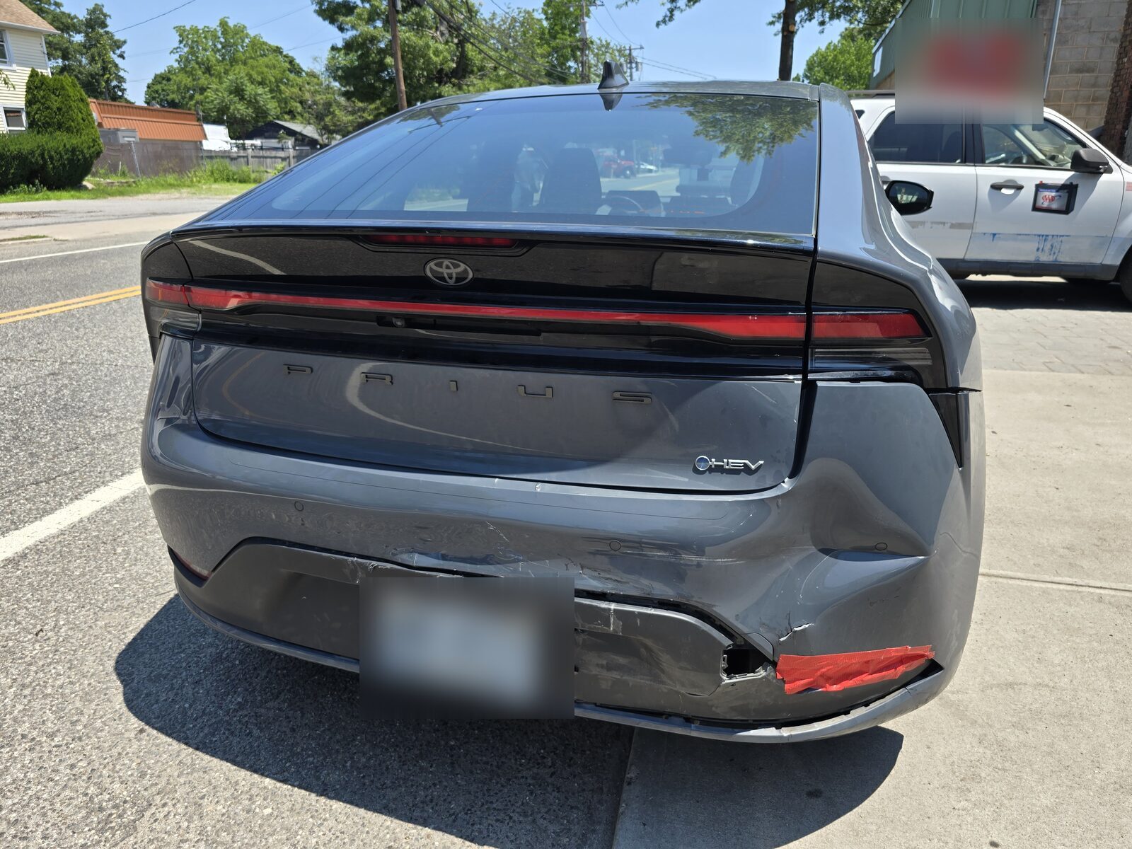 Gray sedan with rear bumper collision damage photographed at intake